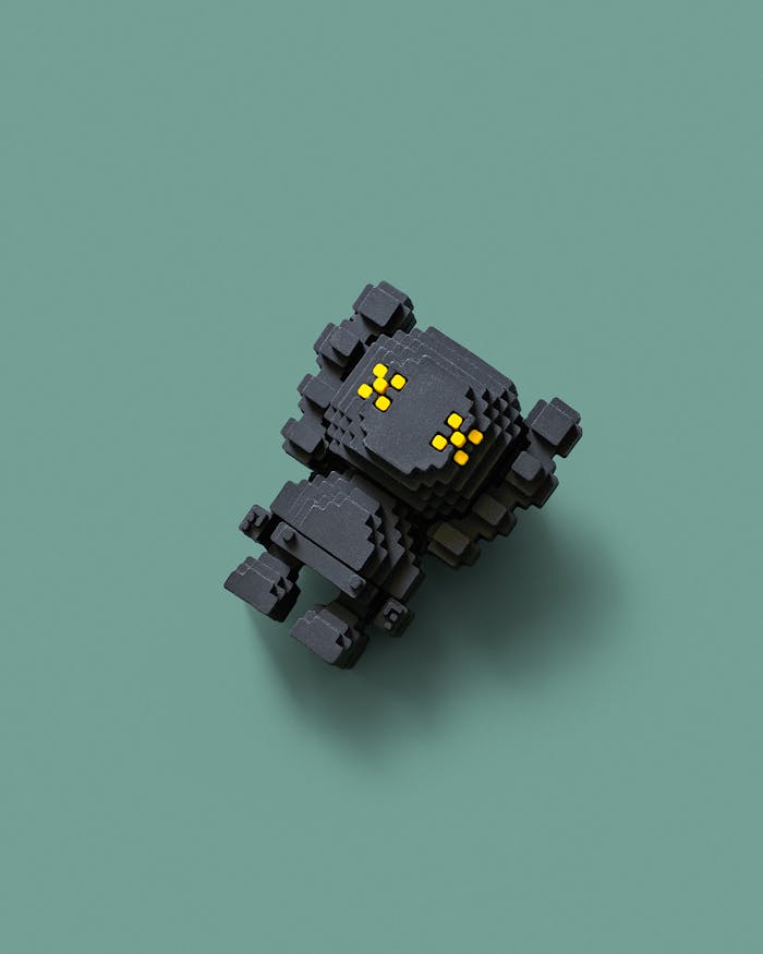 A 3D pixel art robot with yellow eyes on a green background, isolated view.